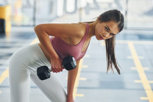 Exercises for endurance. Beautiful young woman with slim body type is in the gym.
