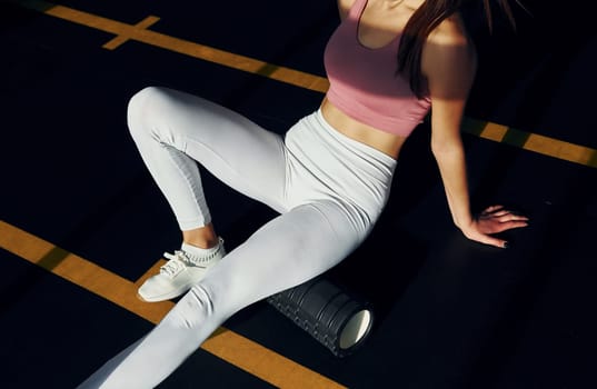 Weekend activities. Beautiful young woman with slim body type is in the gym.