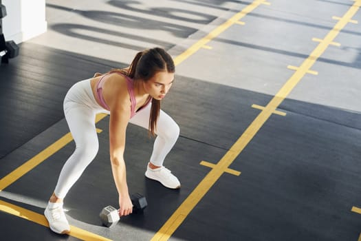 Young woman with slim body type is in the gym.