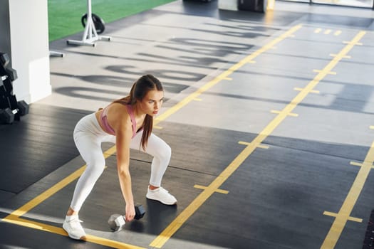 Young woman with slim body type is in the gym.