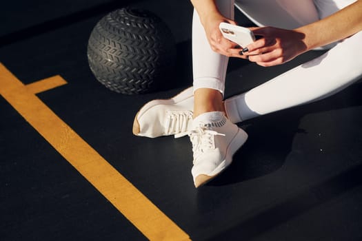 Tired beautiful young woman with slim body type is in the gym.