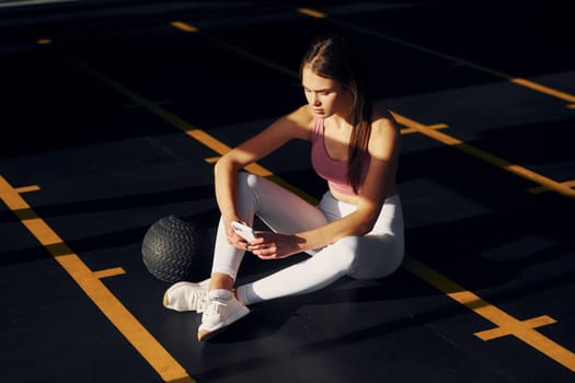 Tired beautiful young woman with slim body type is in the gym.