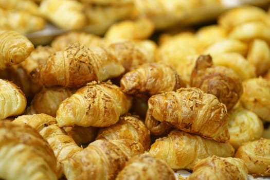 Sale of Cheese croissants and other pastries on the counter in the Supermarket in Surabaya, Indonesia. Selectieve focus and defocused.