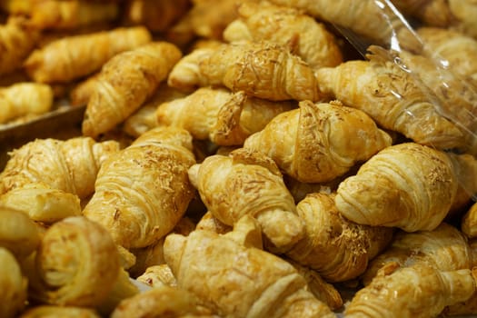 Sale of Cheese croissants and other pastries on the counter in the Supermarket in Surabaya, Indonesia. Selectieve focus and defocused.