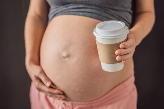 A pregnant woman holds a cup of coffee in her hands. Caffeine safety, myths about coffee during pregnancy concept.