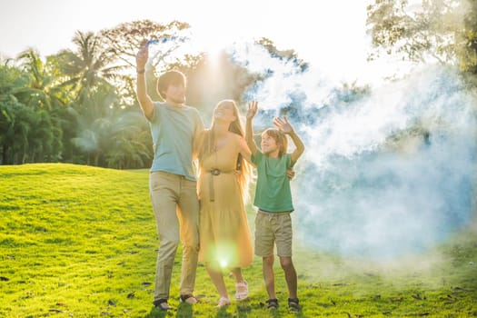 Pregnant mom, dad and son at the gender party on the golf course release blue smoke. Gender reveal announcement on the golf course. Loving family expecting baby boy. Happy moments.