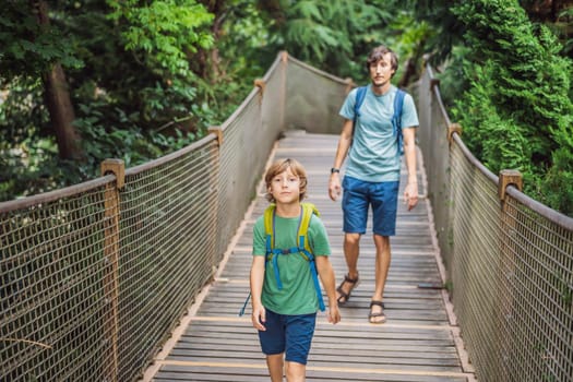 father and son tourists in Rope bridge in Yildiz Park. Besiktas, Istanbul, Turkey. Turkiye. Traveling with kids concept.