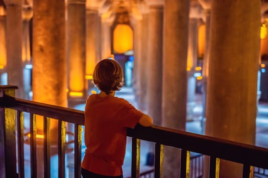 boy tourist enjoying Beautiful cistern in Istanbul. Cistern - underground water reservoir build in 6th century, Istanbul, Turkey, Turkiye.