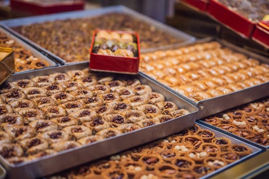 Traditional oriental sweet pastry cookies, nuts, dried fruits, pastilles, marmalade, Turkish desert with sugar, honey and pistachio, in display at a street food market.