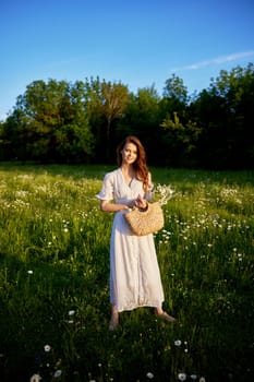 a beautiful woman in a light, light, summer dress is standing in a flowering meadow in the sunset light. High quality photo