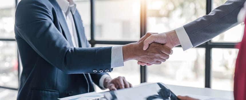 Business handshake for teamwork of business merger and acquisition,successful negotiate,hand shake,two businessman shake hand with partner to celebration partnership and business deal concept