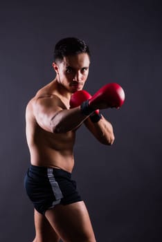 Training, young man and boxer with boxing gloves for a competition, prepare for match