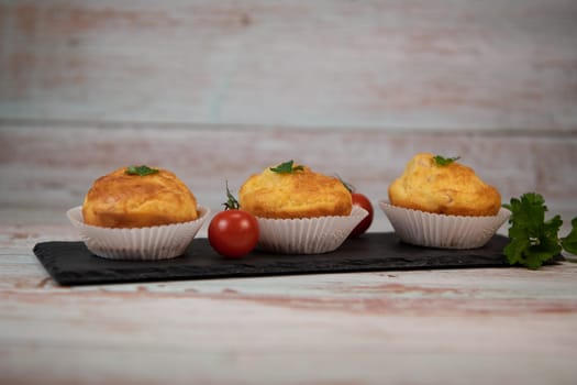 Savory muffin with ham and cheese on blue background, High quality photo