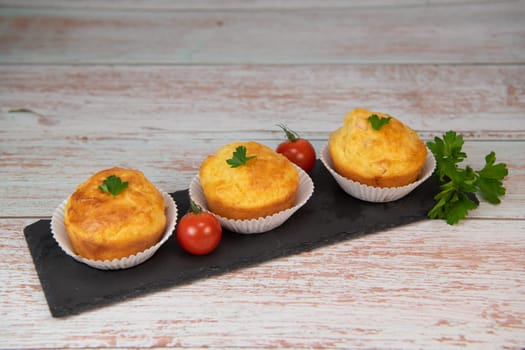 Savory muffin with ham and cheese on blue background, High quality photo