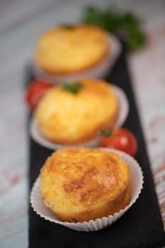 Savory muffin with ham and cheese on blue background, High quality photo