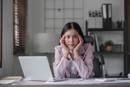 asian woman thinking hard concerned about online problem solution looking at laptop screen, worried serious asian businesswoman focused on solving difficult work computer task...