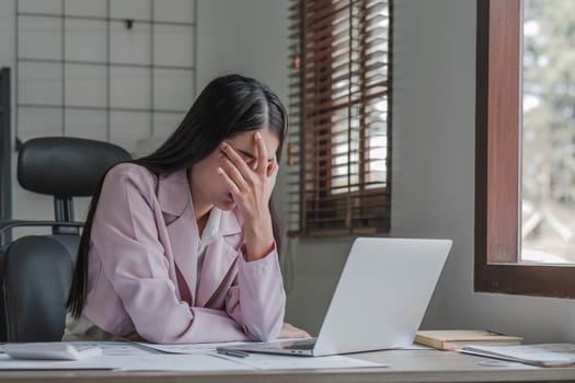 asian woman thinking hard concerned about online problem solution looking at laptop screen, worried serious asian businesswoman focused on solving difficult work computer task...