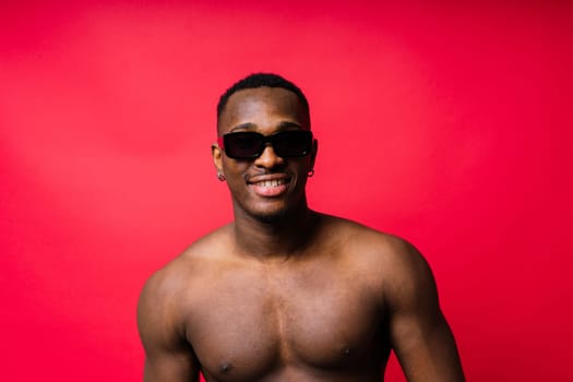 Like what you see. A handsome and muscular young man posing in a studio.