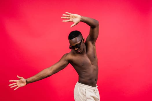 Like what you see. A handsome and muscular young man posing in a studio.