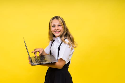 Little happy blonde kid girl 12-13 years laptop computer. Children lifestyle childhood concept.