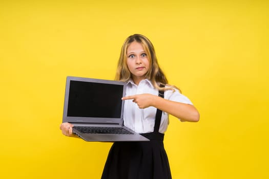 Little happy blonde kid girl 12-13 years laptop computer. Children lifestyle childhood concept.