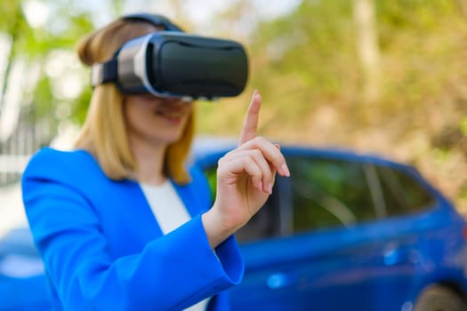 Business woman using VR goggles, moving her head touching the simulation screen with blue car on the background