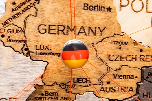 Germany flag pins and red thread for traveling and planning trips. Planning of logistics routes or spheres of influence in geopolitics
