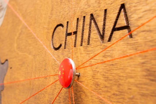 China flag pins and red thread for traveling and planning trips. Planning of logistics routes or spheres of influence in geopolitics