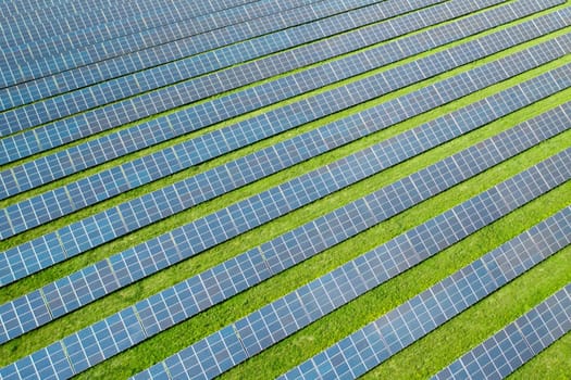 Aerial view of a solar panel for green energy production in a field. Cheap electricity or increasing of price on electricity resources concept