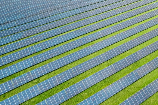 Aerial view of a solar panel for green energy production in a field. Cheap electricity or increasing of price on electricity resources concept