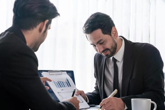 Busy analyst team discussing financial data on digital dashboard, analyzing chart and graph using data science software display on a laptop screen. Business intelligence and Fintech. Fervent