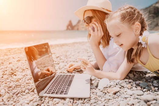 Woman sea laptop. Business woman in yellow hat working on laptop by sea. Close up on hands of pretty lady typing on computer outdoors summer day. Freelance, digital nomad, travel and holidays concept.