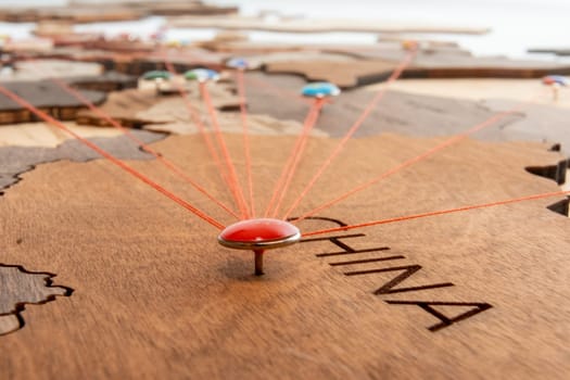 China flag pins and red thread for traveling and planning trips. Planning of logistics routes or spheres of influence in geopolitics