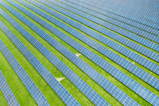 Aerial view of a solar panel for green energy production in a field. Cheap electricity or increasing of price on electricity resources concept