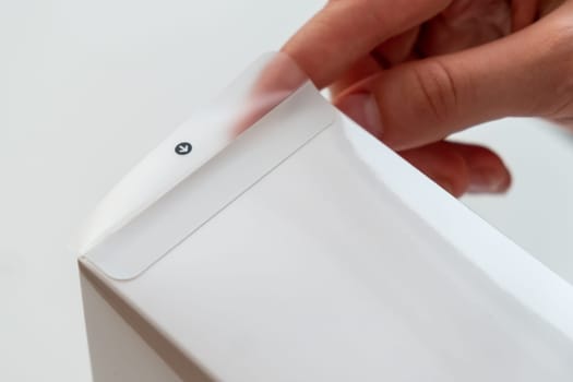 Close up unboxing of a white box by female hands. Getting a gift concept.