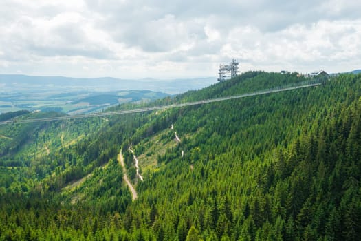 Sky Bridge 721 is the longest suspension bridge between two hills in the forest, Dolni Morava, Czech Republic . One way footbridge in touristic place in the forest in summer.