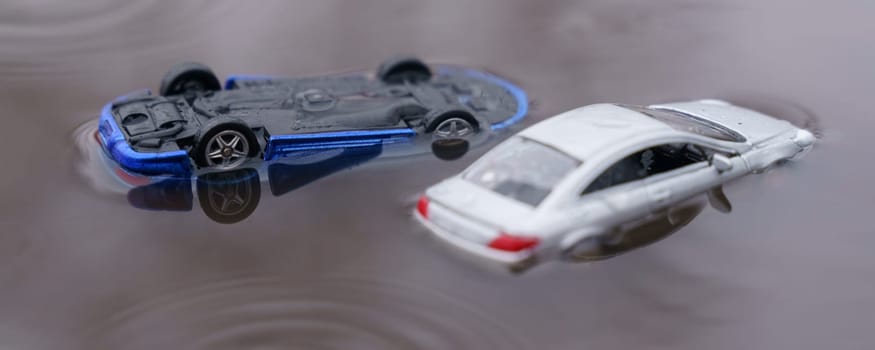 Natural disasters. Two cars were flooded, one overturned as a result of the flood. One of them is out of focus.