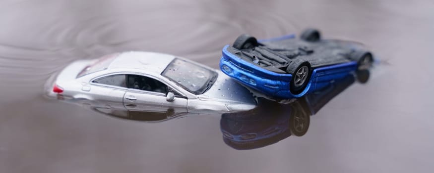 Natural disasters. The cars were flooded, one car is parked above the other. One of them is out of focus.