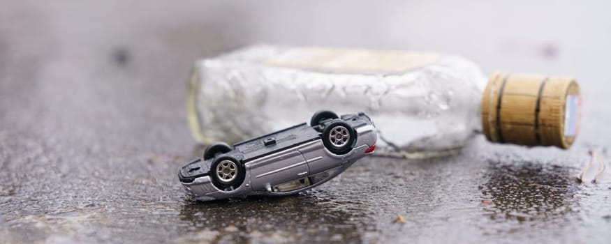 Occurrence. Traffic accident - an overturned car with a bottle of alcohol in the background.