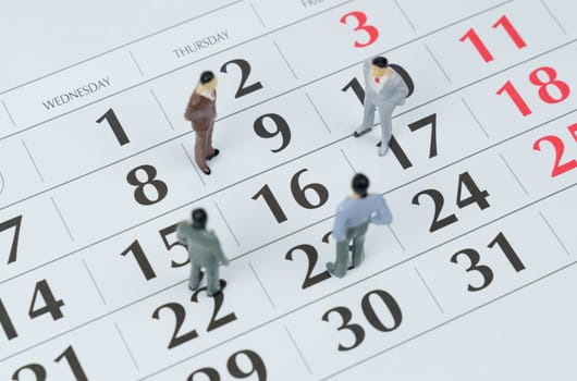 Business and finance concept. There are miniature figures of businessmen on the calendar - business planning