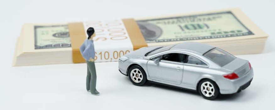 Business concept. On a white surface is a car, a pack of dollars and a miniature figure of a man.