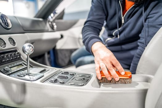 manual cleaning of leather in the car interior with a brush. High quality photo