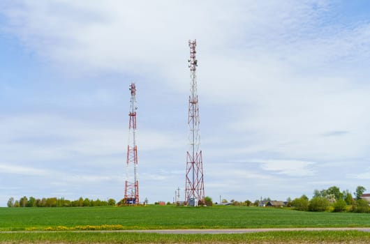 The tower-antenna of the mobile operator is in the field. Communication and telecommunications concept.