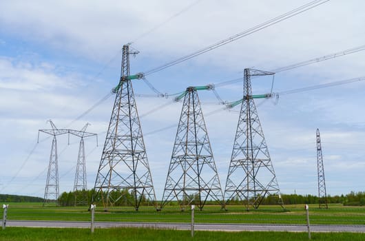 Industrial concept. Towers and high-voltage power lines in the field.