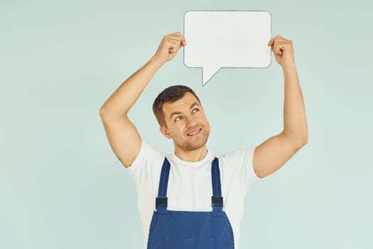 Worker saying something. Man standing in the studio with empty signs for the text.