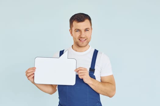 Worker saying something. Man standing in the studio with empty signs for the text.