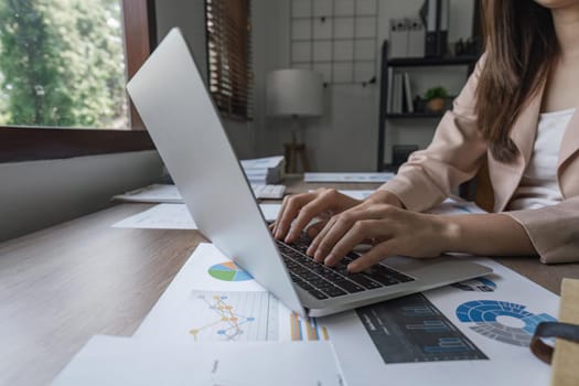 Young Happy Businesswoman Using Computer in Modern Office with Colleagues.