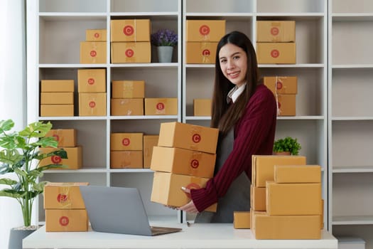 Small businesses SME owners female entrepreneurs check online orders to prepare to pack the boxes, sell to customers, sme business ideas online.