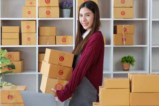 Small businesses SME owners female entrepreneurs check online orders to prepare to pack the boxes, sell to customers, sme business ideas online.