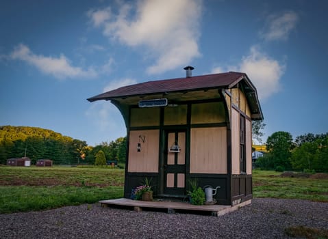 View of a Small Old Train Station, With Flowers on the Deck, Waiting for a Train, on a Summer day